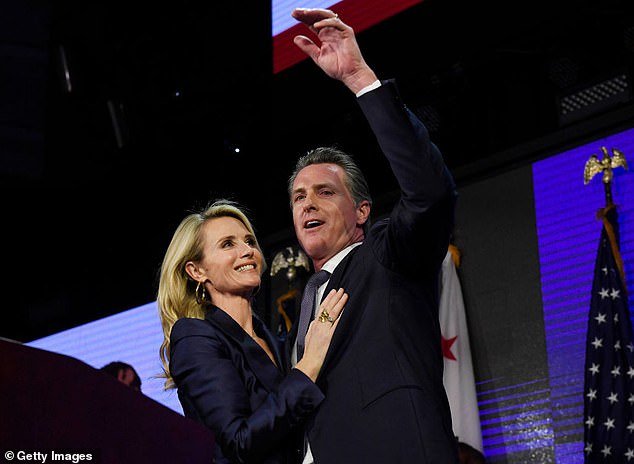 103153455-15210131-Gavin_Newsom_and_his_wife_Jennifer_Siebel_Newsom_wave_to_support-a-8_1761589773591.jpg