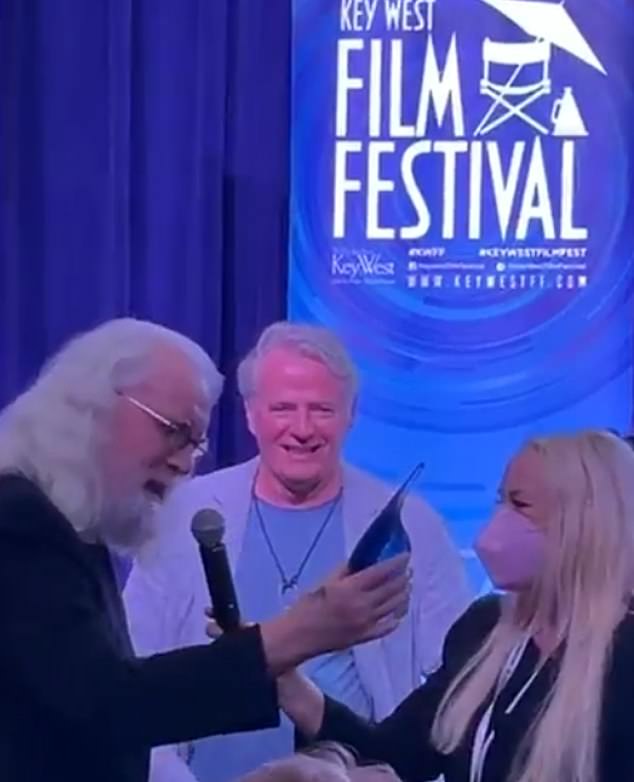 103910663-15294315-Sir_Billy_addresses_the_crowd_as_wife_Pamela_holds_the_mic_for_h-a-23_1763233213619.jpg