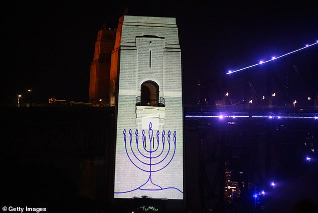 105167009-15427795-An_image_of_a_menorah_is_projected_onto_the_pylons_of_the_Sydney-a-59_1767318346424.jpg