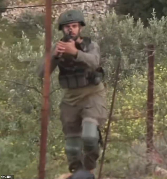 107499231-15688077-A_CNN_news_crew_were_approached_by_armed_Israeli_soldiers_while_-m-3_1774735843113.jpg