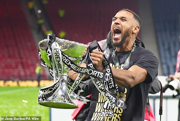 107989455-15744799-Ayunga_celebrates_with_the_Premier_Sports_trophy_that_he_helped_-a-28_1776547431379.jpg