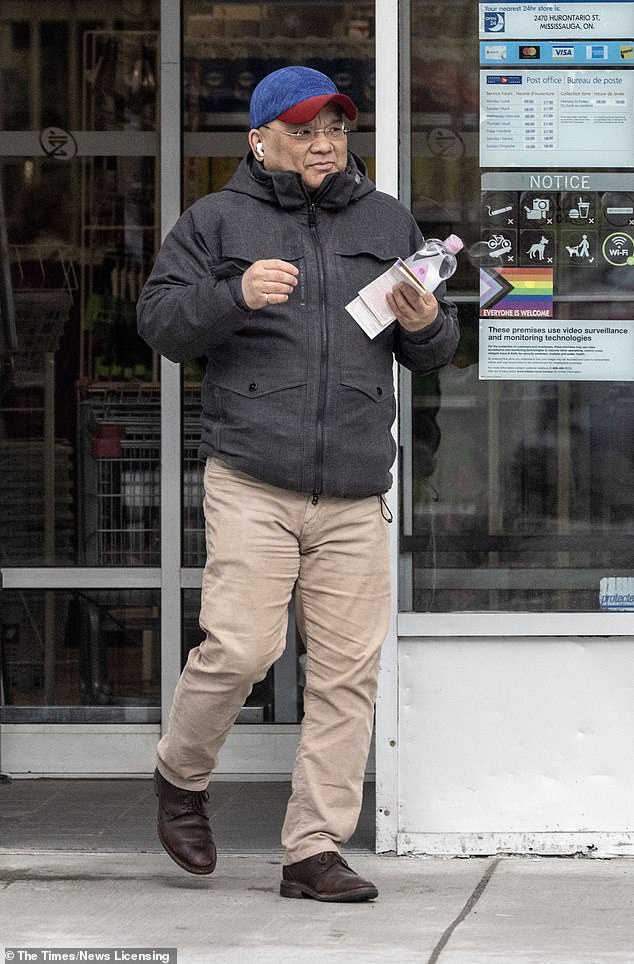 71393391-15746927-Kenneth_Law_pictured_leaves_the_post_office_in_Mississauga_Ontar-a-11_1776638250431.jpg