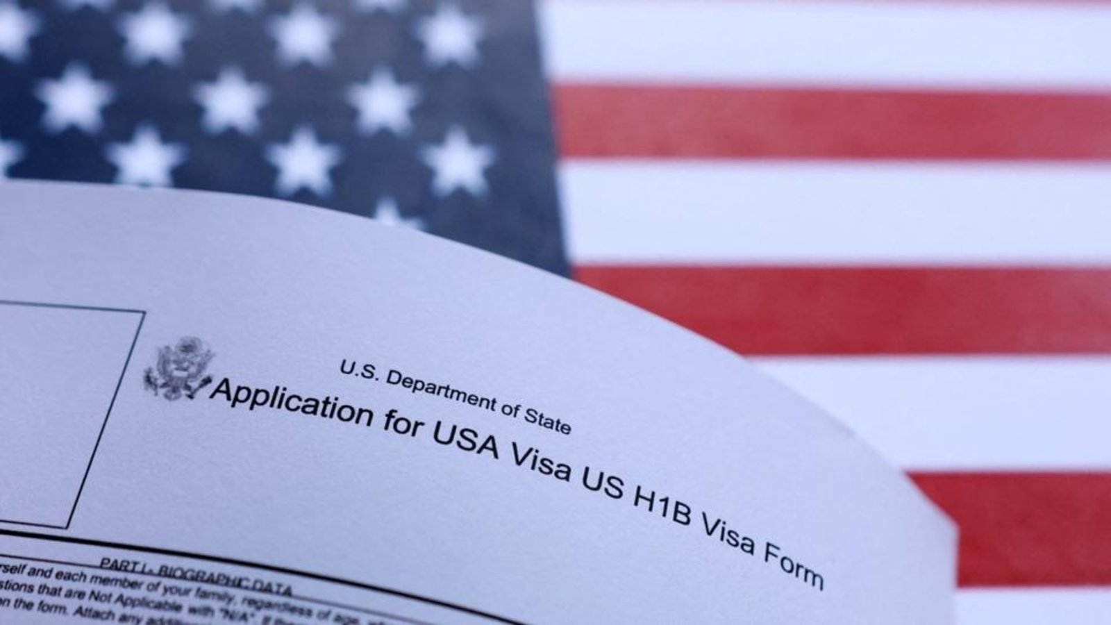 A-US-flag-and-US-H-1B-visa-application-form-are-se_1761472494320_1761472590817.jpg